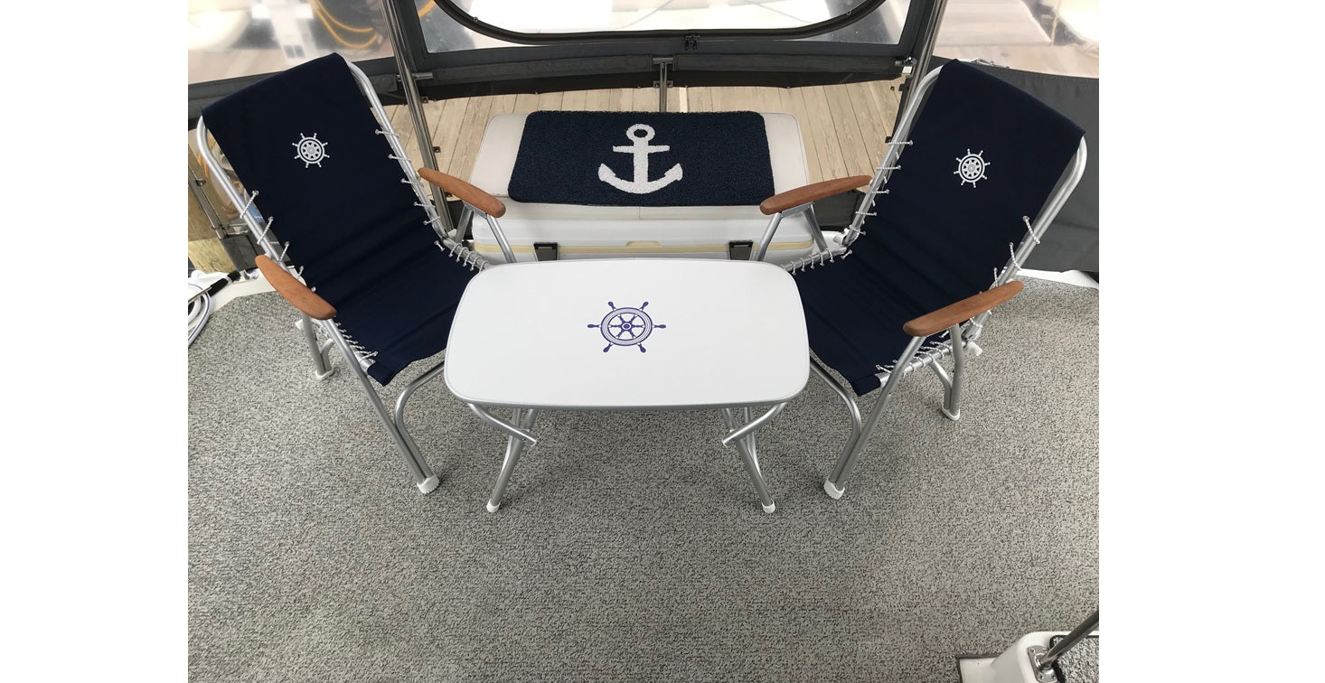 2 forma marine boat chairs navy blue on a boat deck with an m250 boat table between them